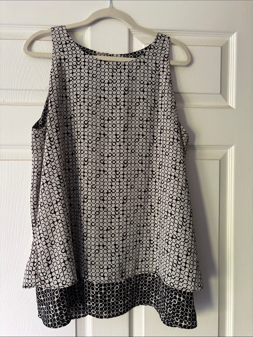 B&W sleeveless blouse; 2-layers with inside layer being longer than outer.